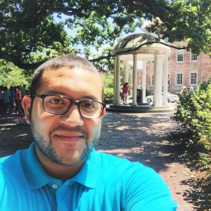 Ricky takes a selfie in front of the Old Well at UNC.